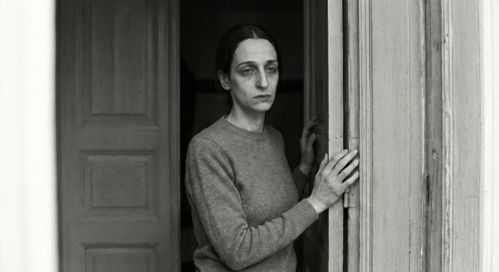 Hana in a half-open doorway, black-and-white
